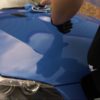 Blue BMW being polished with microfibre cloth