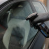 Aurora Vehicle Glass Cleaner being sprayed onto car window