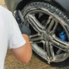 Wheel cleaning fluid being used to clean wheel and tyre on car